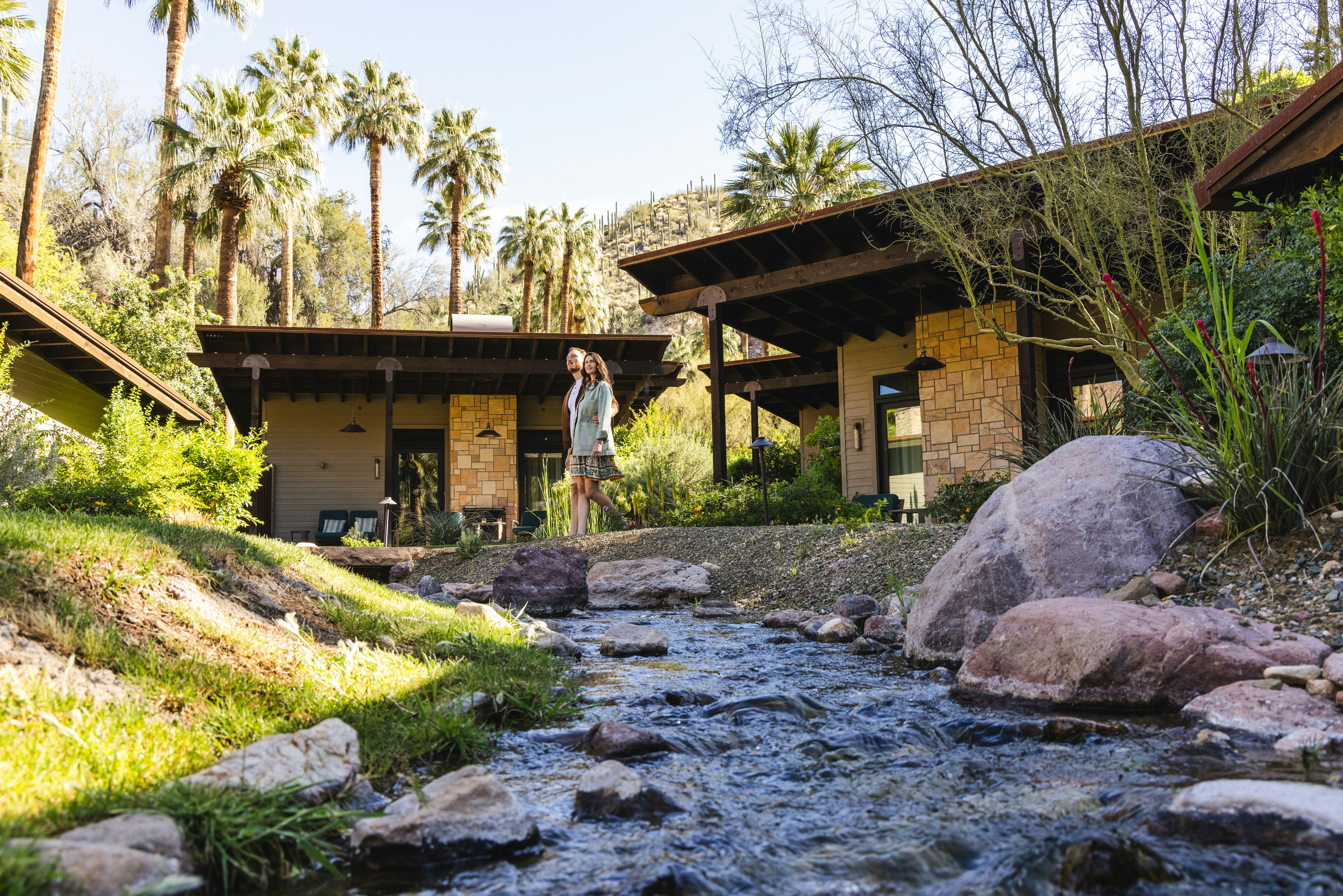 Couple walking past Spring Bungalows at Castle Hot Springs