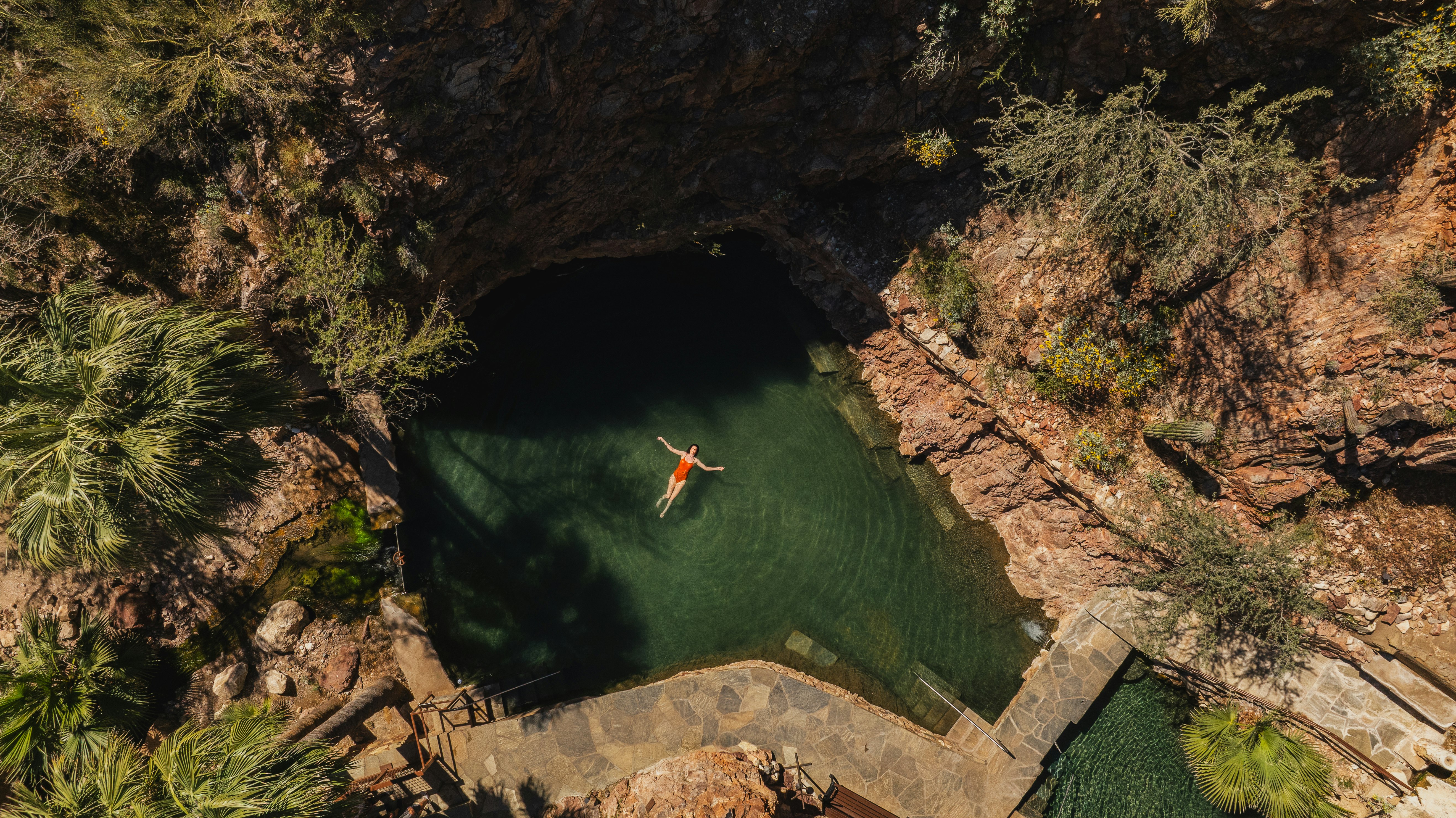 Aerial of Woman Swimming in the Hot Springs at Castle Hot Springs
