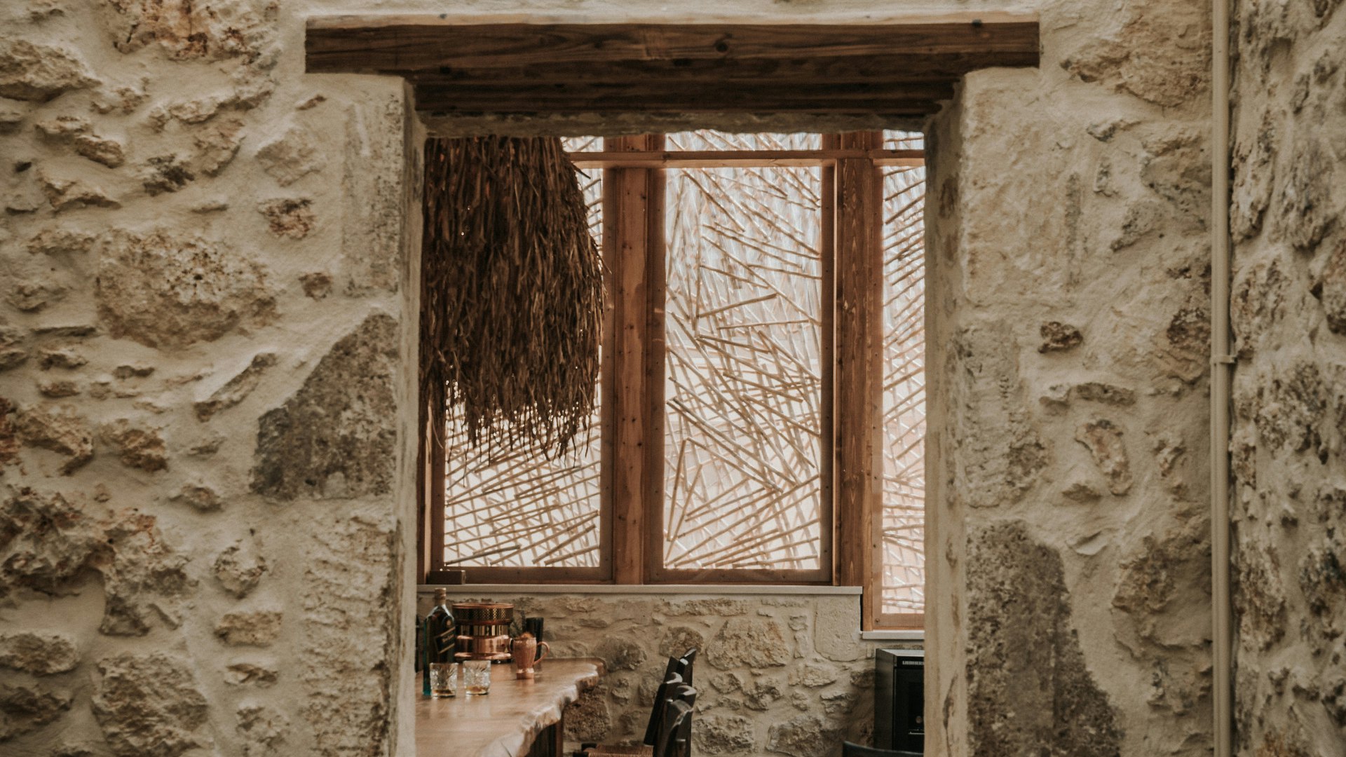 Stone-framed view of the bar area in Manili Bistro