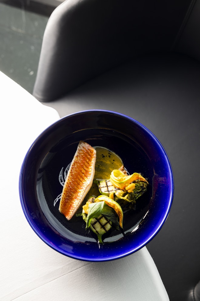 Red snapper filet with tapenade, zucchini and flowers
