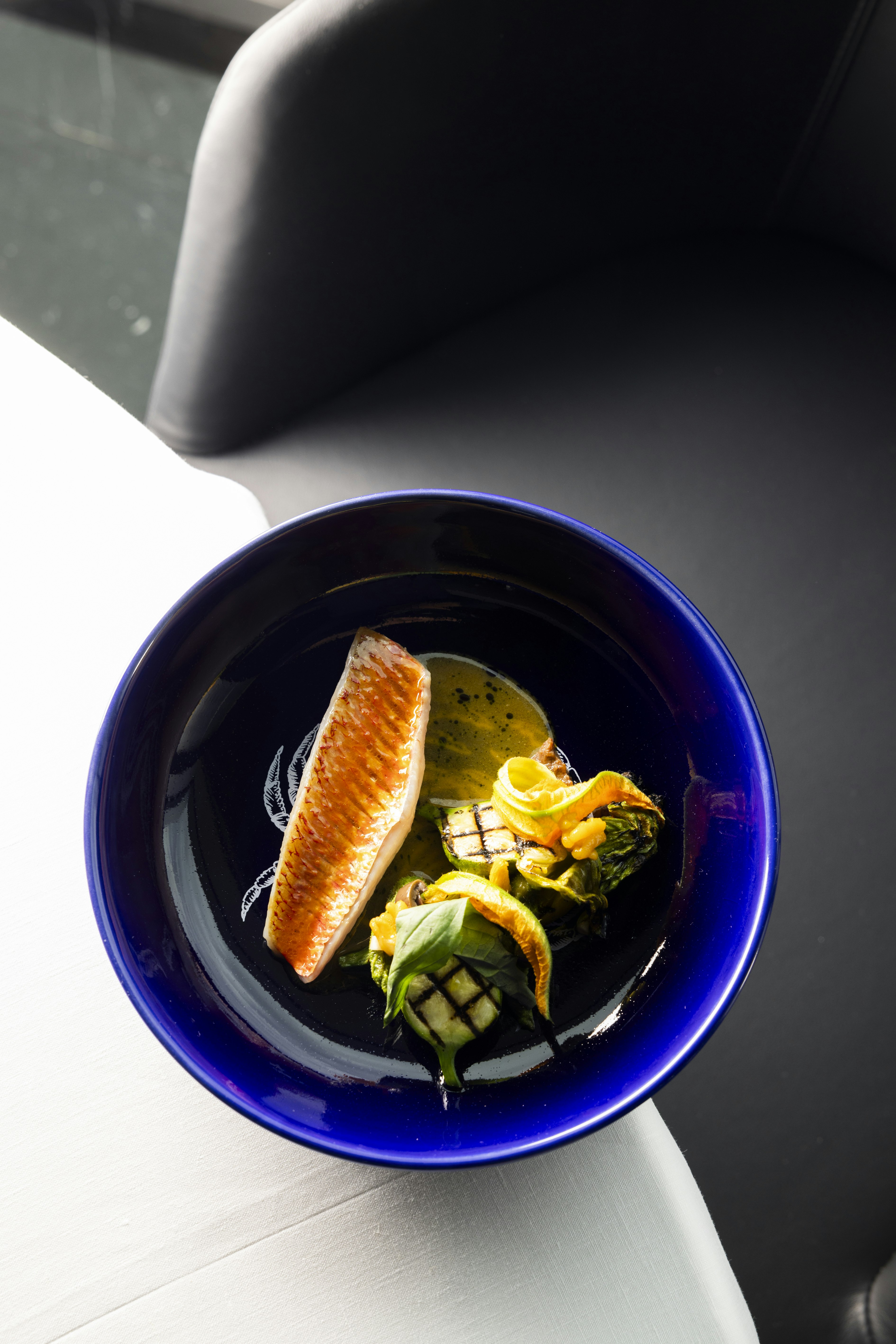 Red snapper filet with tapenade, zucchini and flowers